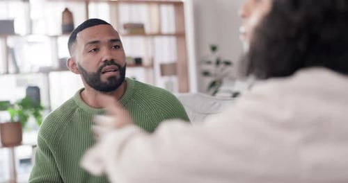 Man Talking to Individual in an Interior Setting