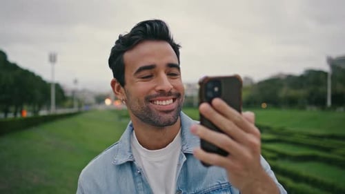 Positive Tourist Video Calling By Mobile Phone Spending Weekend in Park Close Up