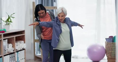 Adult Assists Senior in Stretching Exercise