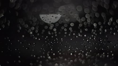Raindrops at night creative footage black background. Rainy weather. Take four.