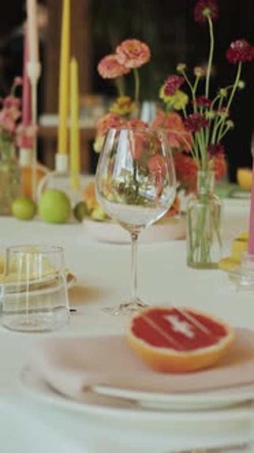 Decorated Table with Wineglass, Candles, and Flowers