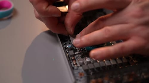 Hands Connecting Ribbon Cable to Circuit Board