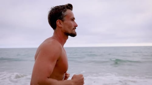Athletic Man Exercising At The Beach