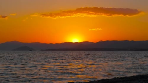 Orange Sun Between Clouds During Dusk