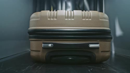 VFX Graphics Visualizing Xrays Illuminating Inside of Suitcase Moving on Conveyor Belt in Airport