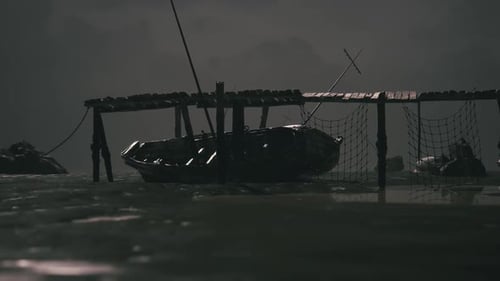 Dark Waters with a Boat Moored Under a Wooden Pier at Twilight