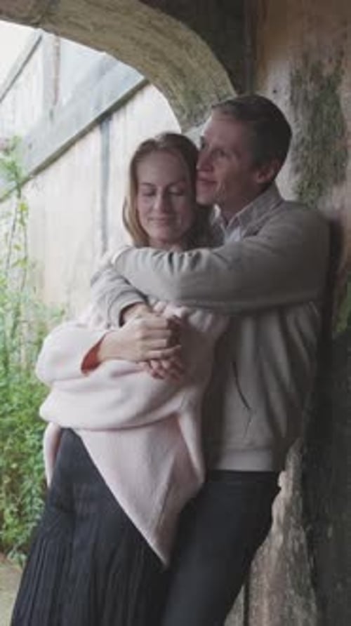 Romantic Couple Embracing in a Castle Archway