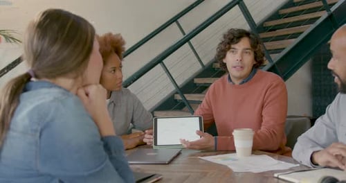 Diverse Team Collaborating on Project in Modern Office