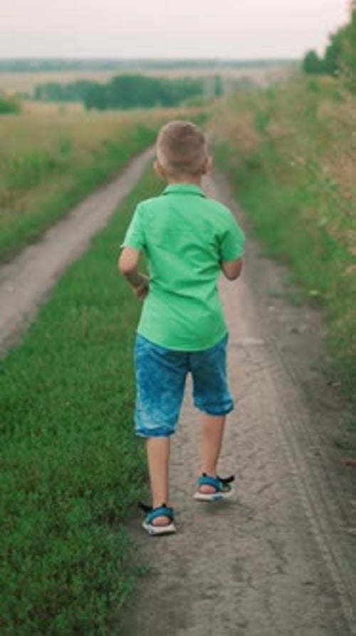 Mother Walking Dog on Rural Path While Child in Green Shirt Walks Ahead