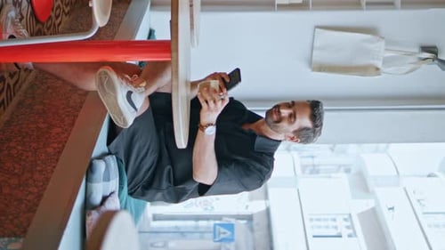 Two Guys Sitting Cafeteria Looking Smartphone Cafe Visitors Relaxing Vertical