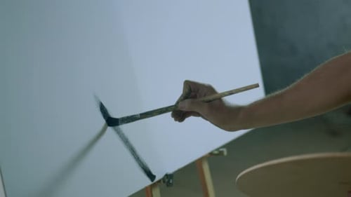 Painter painting on a white canvas