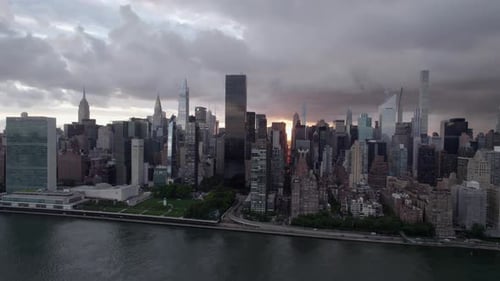 Aerial view of the riverside of Midtown East, gloomy evening in NYC, USA - pan, drone shot