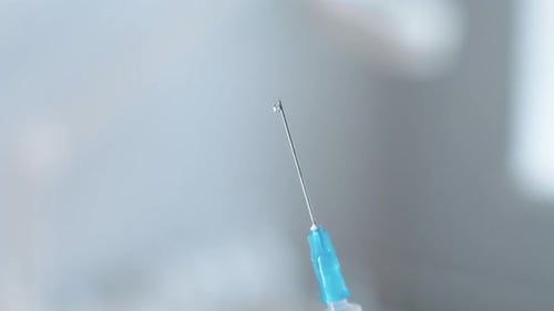 Close-up of Syringe Needle with a Drop