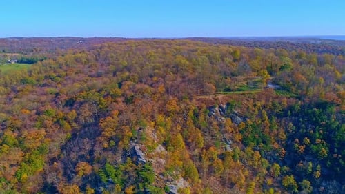Aerial View of Autumn Tree Colors Along a Major River on a Sunny Fall Day