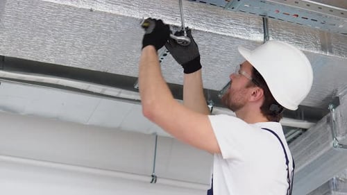 Engineer Tightening Bolt on Overhead Cable Trays