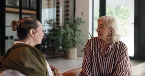 Friends, relax and women in lounge, talking and bonding with gossip in home, happy and conversation