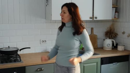 Woman Dancing in Kitchen, Having Fun at Home