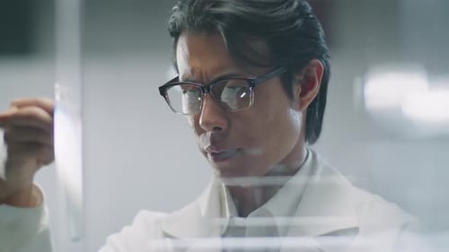 Scientist Examining Test Tube in Clean Lab