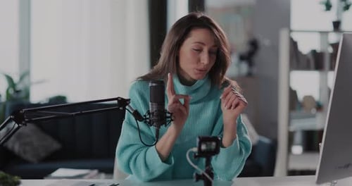 Woman Presenting with Microphone in Home Office