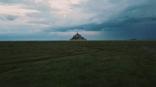 Mont Saint-Michel Against Cloudy Sky In Normandy, France - drone forward