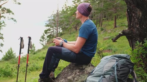 Hiking Climbing Cliff Adventure Backpacker Man Resting After Hiking Looking at Beautiful View Hiker