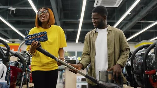African American Couple Selecting a Vacuum Cleaner in Tech Store