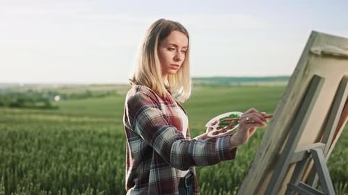 Seductive Blonde Woman Holding Brush and Color Palette Painting Outdoors
