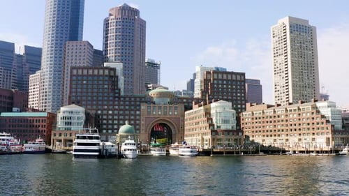 Low drone shot of Boston skyline from Boston harbor