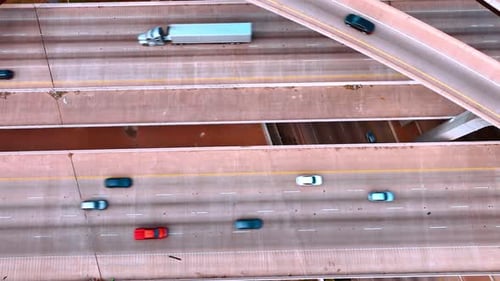 Quickly moving cars on the multi-lane parallel roads under the trestles.