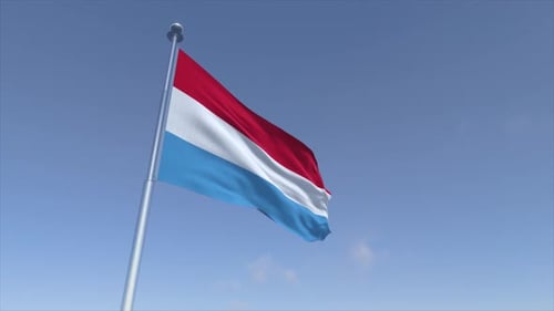 Luxembourg Flag Waving Against a Clear Blue Sky