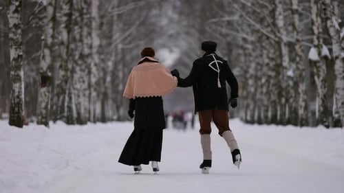 A Snowcovered Alley Becomes an Ideal Place for a Couple Skating Their Elegance and Joy Create an