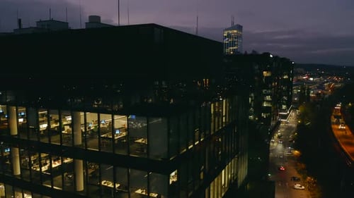 Cinematic Panorama of LateNight Office Work in a Glass Skyscraper