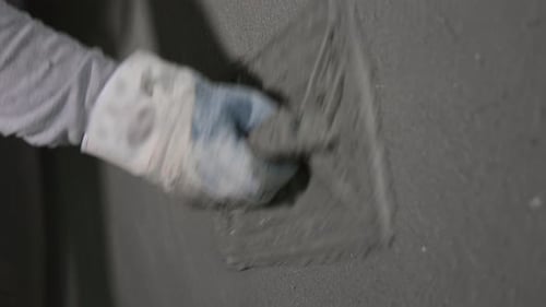 Applying Plaster to Wall with Trowel