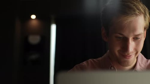 Closeup Tracking Shot of Smiling Businessman Working on Laptop Computer at Home Office Sitting at