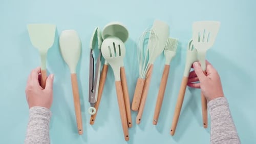 Light Green Kitchen Utensils on Light Blue Surface