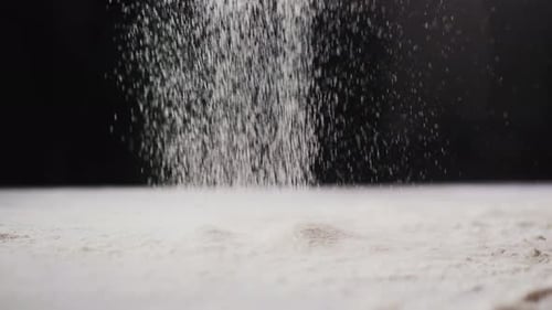 Flour Being Poured onto a White Pile