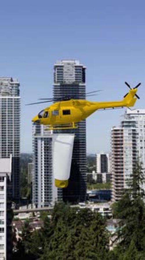 Yellow Helicopter Carrying Large Bucket Over City Vertical