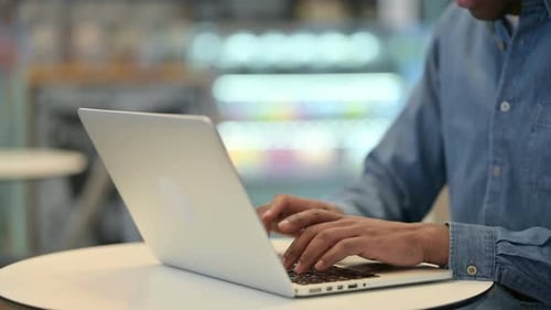 African Man Typing On Laptop Keyboard, Close Up