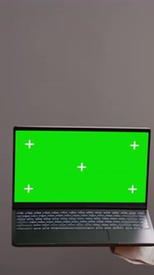 Vertical Video Restaurant Employee Pointing at Greenscreen Layout on Pc
