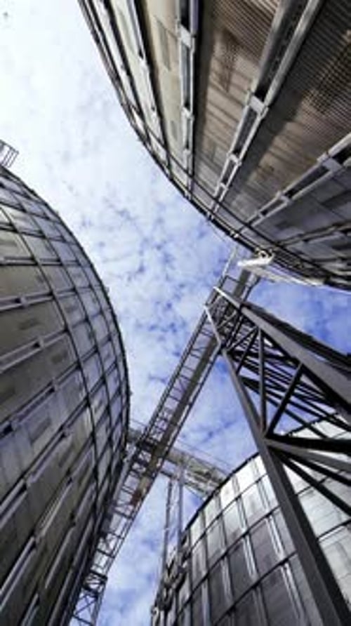 Modern grain terminal. Metal storage tanks for drying grain. Industrial equipment for agribusiness.