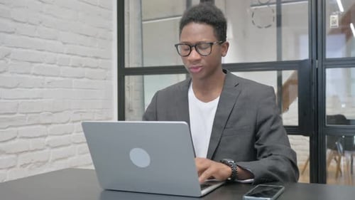 Young Adult Using Laptop has a Headache