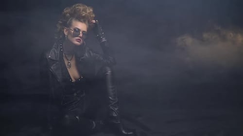 Woman in Leather Jacket Sitting in Studio