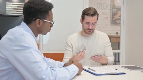 Mixed Raced Business People Exchange Money and Shake Hand