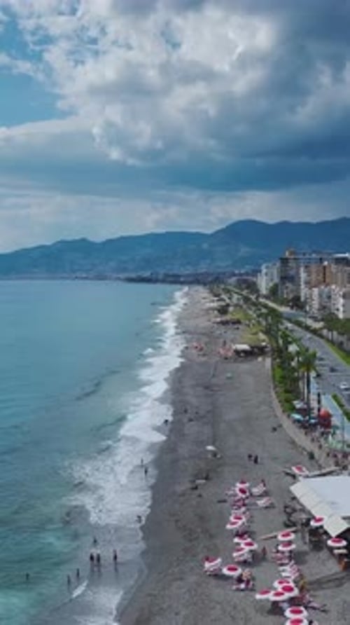 Vertical Video Mediterranean Coastline with Azure Waters and a Vibrant City Offering Stunning Views
