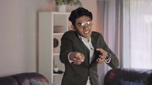 Young Adult Dances and Points at the Camera