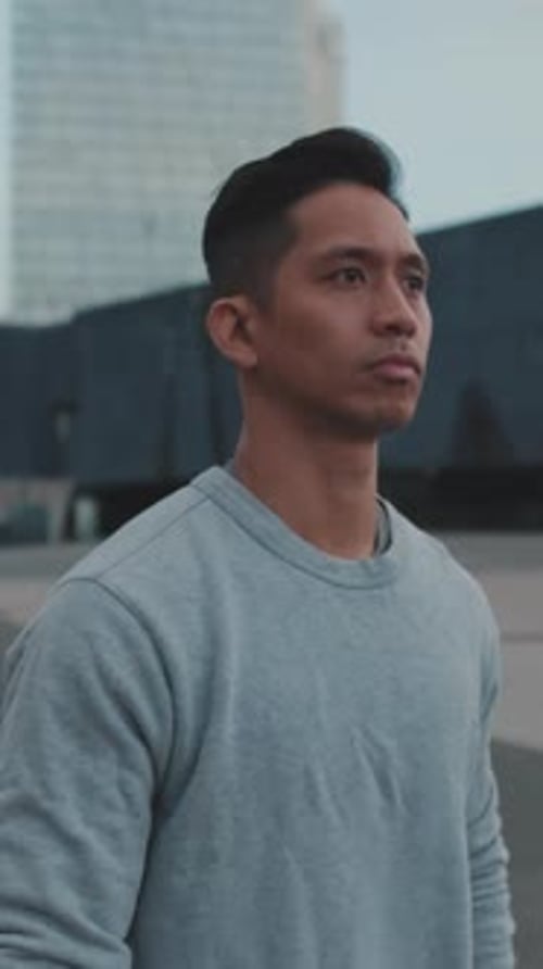 Man Walking in Urban Environment on a Cloudy Day