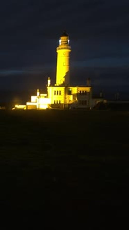 Tall Lighthouse Glowing in Golden Sunlight at Sunset