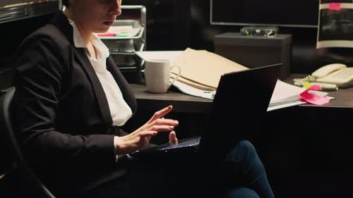 Woman Typing on Laptop in Office