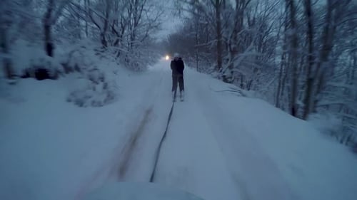 skier being pulled by an off-road car