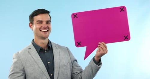 Young Man Holding Pink Speech Bubble